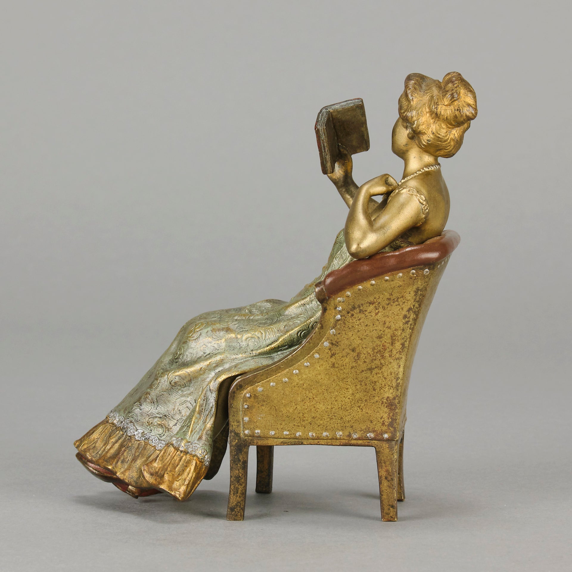 Lady Reading by Franz Bergman an attractive early 20th Century Austrian bronze study of a seated lady wearing a loosley fitted night dress reading a book, her dress lifting to reveal her beautiful body