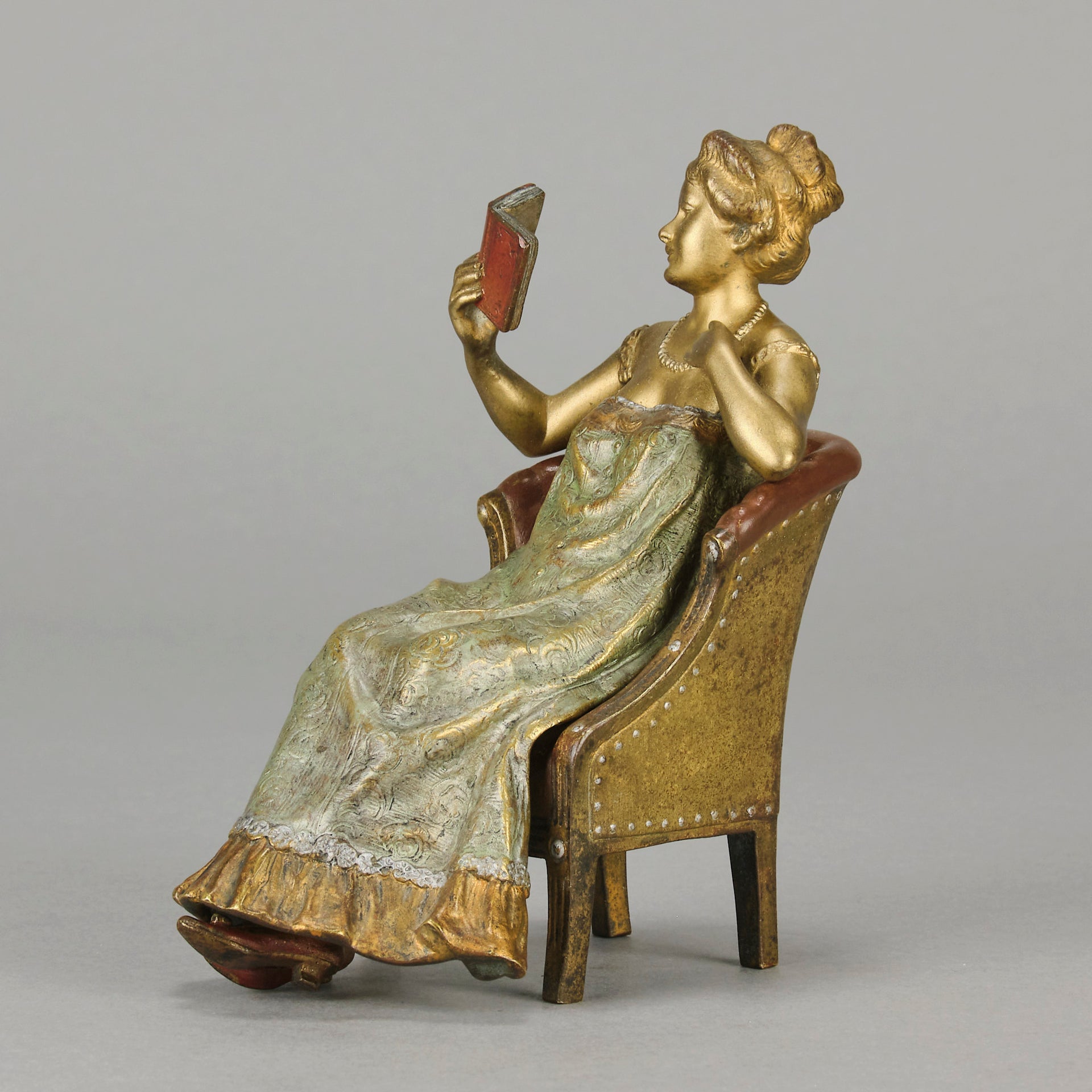 Lady Reading by Franz Bergman an attractive early 20th Century Austrian bronze study of a seated lady wearing a loosley fitted night dress reading a book, her dress lifting to reveal her beautiful body