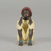 Seated Boy by Franz Bergman an early 20th Century cold painted Austrian bronze figure of a young Arab boy dressed in full period orientalist attire seated with his head resting upon his hands in deep thought