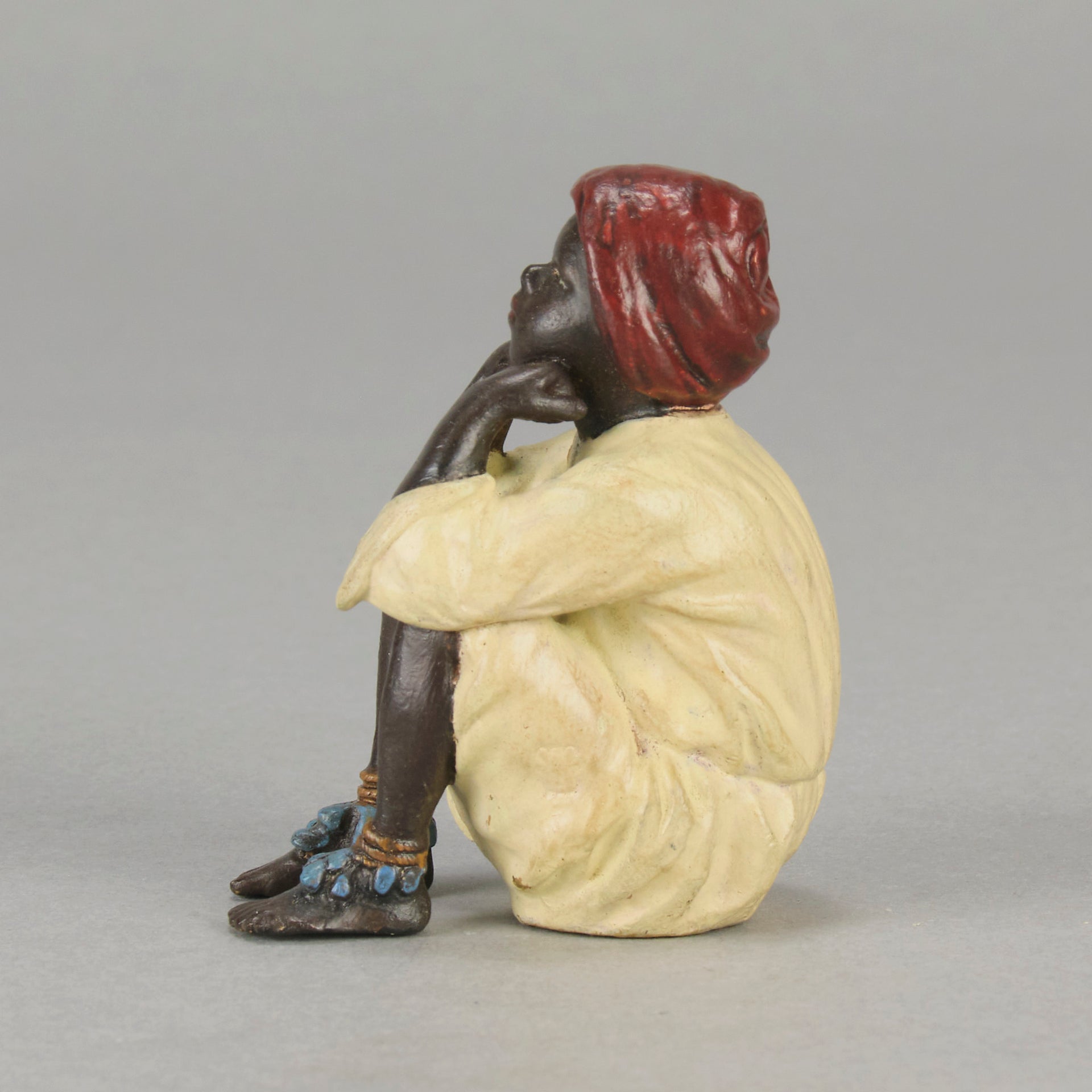 Seated Boy by Franz Bergman an early 20th Century cold painted Austrian bronze figure of a young Arab boy dressed in full period orientalist attire seated with his head resting upon his hands in deep thought