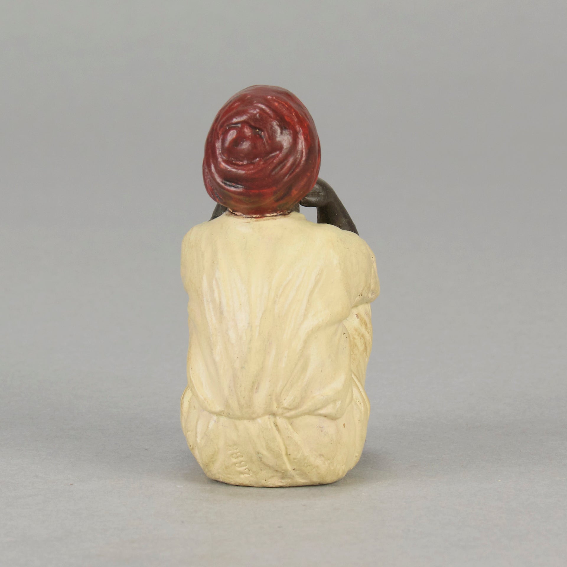 Seated Boy by Franz Bergman an early 20th Century cold painted Austrian bronze figure of a young Arab boy dressed in full period orientalist attire seated with his head resting upon his hands in deep thought