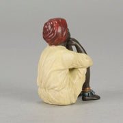 Seated Boy by Franz Bergman an early 20th Century cold painted Austrian bronze figure of a young Arab boy dressed in full period orientalist attire seated with his head resting upon his hands in deep thought