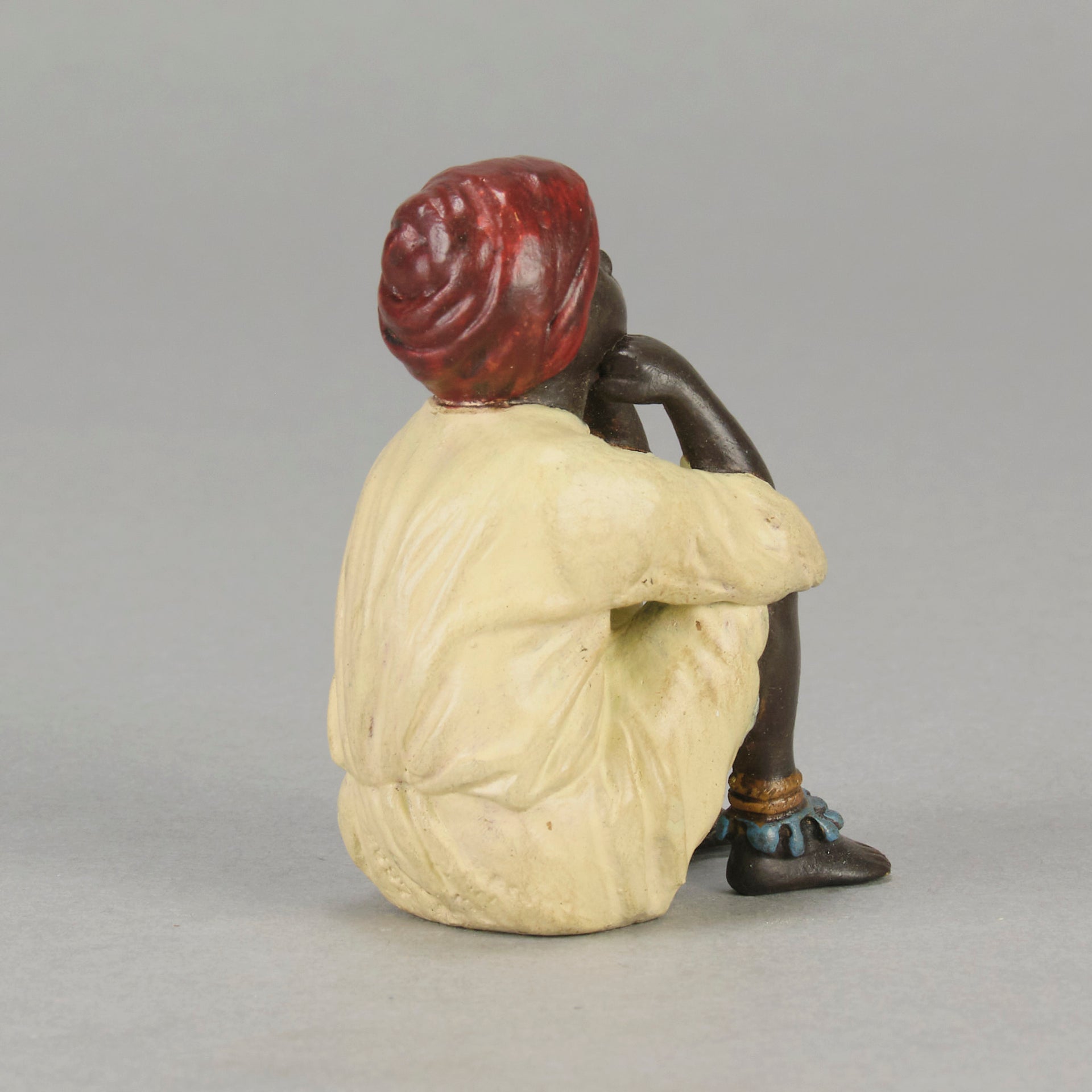 Seated Boy by Franz Bergman an early 20th Century cold painted Austrian bronze figure of a young Arab boy dressed in full period orientalist attire seated with his head resting upon his hands in deep thought