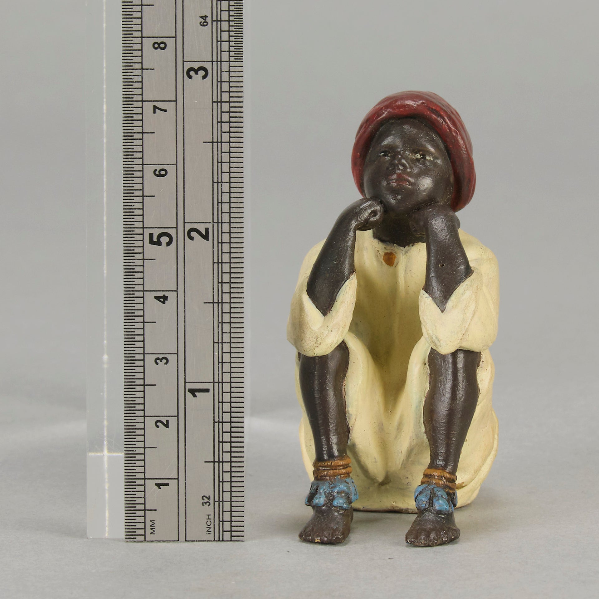 Seated Boy by Franz Bergman an early 20th Century cold painted Austrian bronze figure of a young Arab boy dressed in full period orientalist attire seated with his head resting upon his hands in deep thought