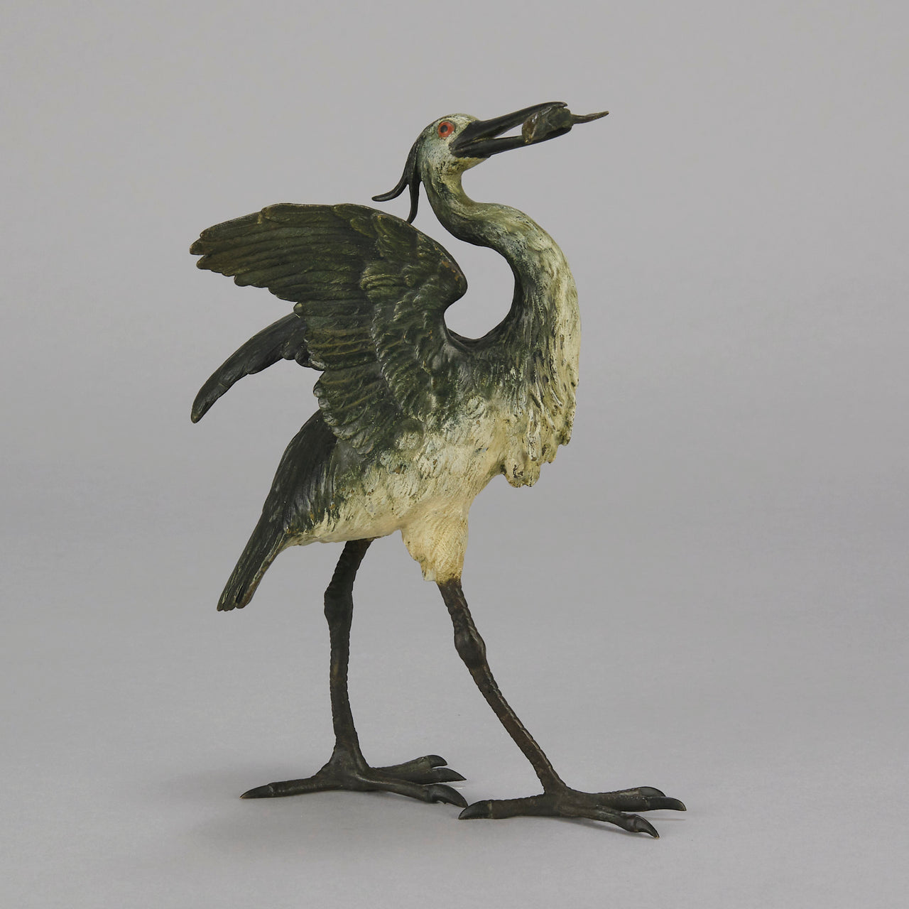 A Standing Stork with Fish Antique Bronze Statue by Franz Bergman exhibiting very fine cold painted colours and good hand finished surface detail