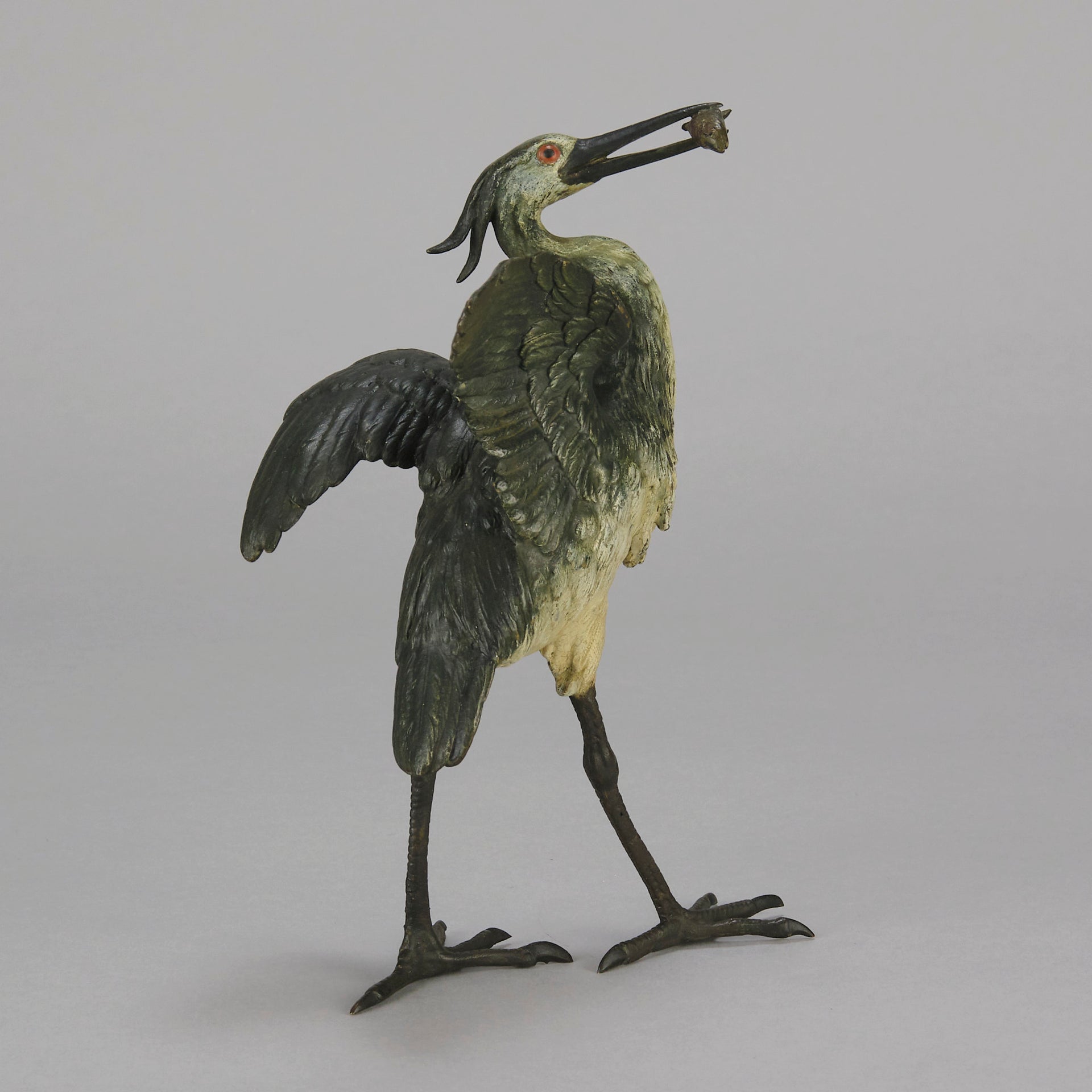 A Standing Stork with Fish Antique Bronze Statue by Franz Bergman exhibiting very fine cold painted colours and good hand finished surface detail