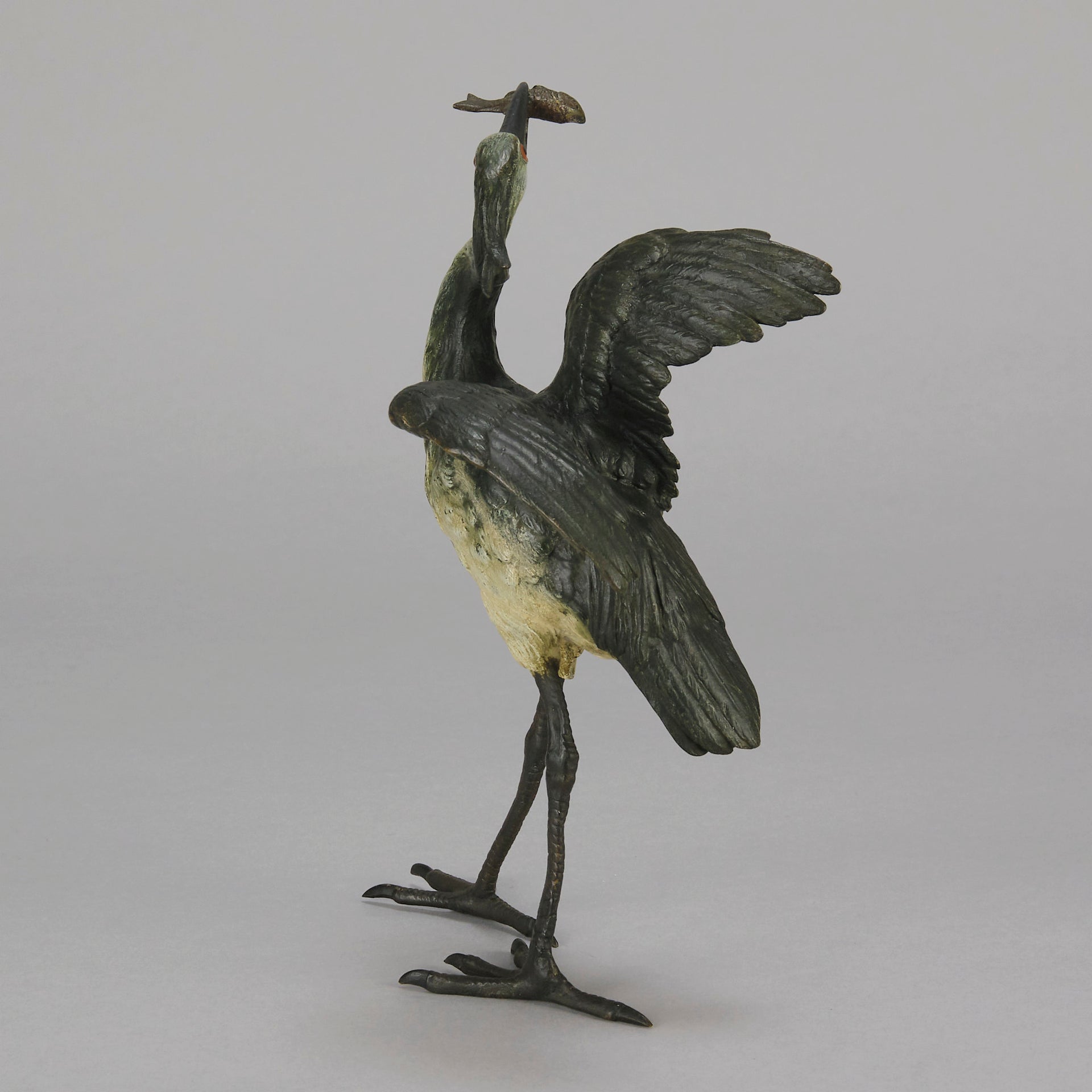 A Standing Stork with Fish Antique Bronze Statue by Franz Bergman exhibiting very fine cold painted colours and good hand finished surface detail