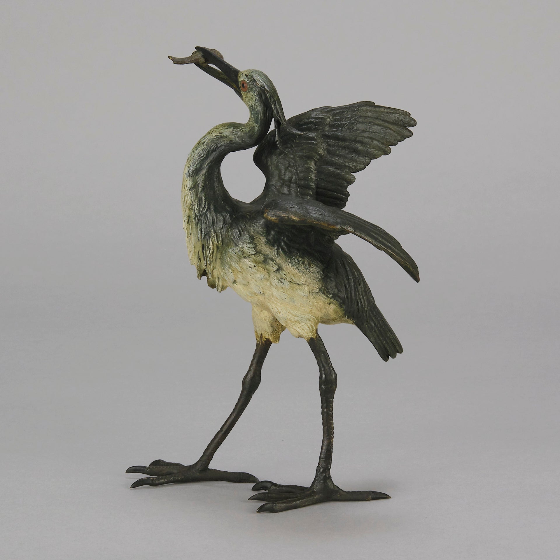 A Standing Stork with Fish Antique Bronze Statue by Franz Bergman exhibiting very fine cold painted colours and good hand finished surface detail