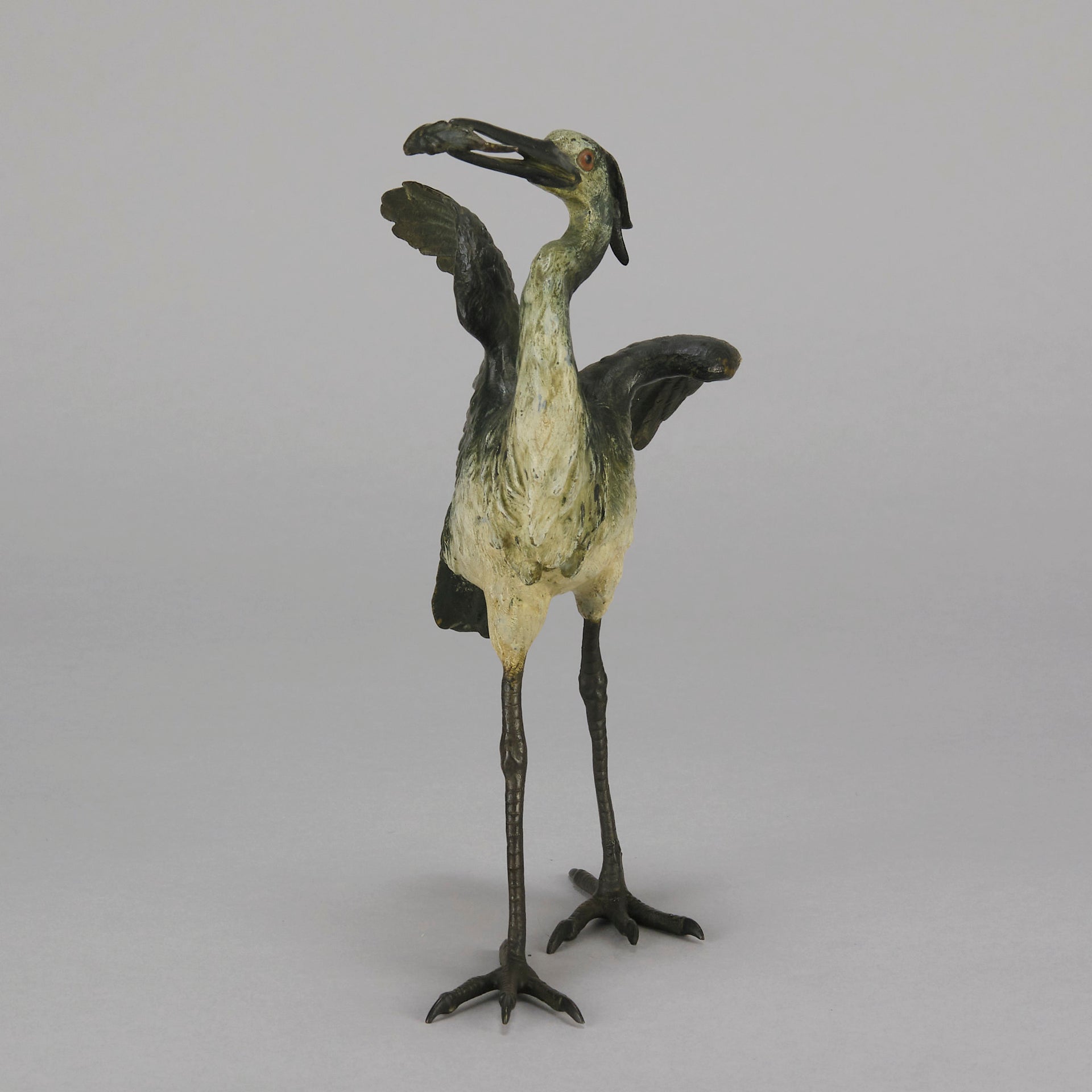 A Standing Stork with Fish Antique Bronze Statue by Franz Bergman exhibiting very fine cold painted colours and good hand finished surface detail