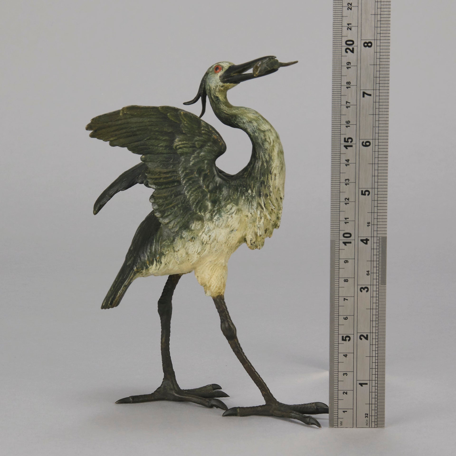 A Standing Stork with Fish Antique Bronze Statue by Franz Bergman exhibiting very fine cold painted colours and good hand finished surface detail