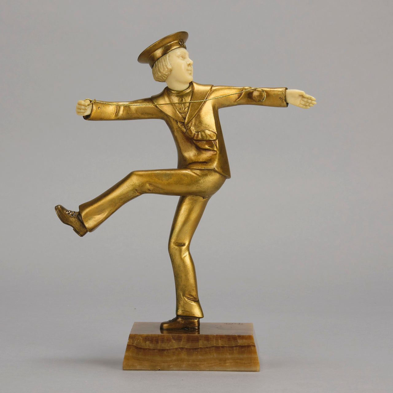 Art Deco Bronze Figurine Yo Yo by Gallo Gilt Bronze Sculpture of a young man dressed in period sailor boy attire performing tricks with his yo-yo whilst balancing on one leg. The figure with excellent hand carved detail and fine golden colour 