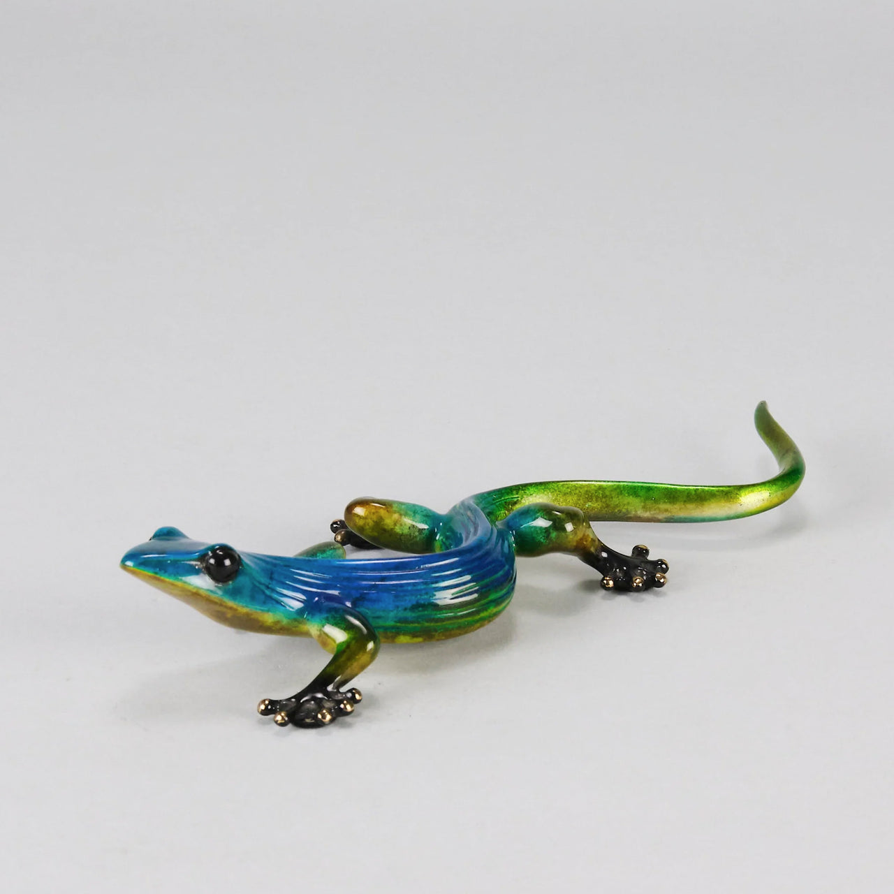 Margarita Gecko by Tim Cotterill a bronze study of a gecko with its head raised exhibiting very fine vibrant colours and excellent surface detail