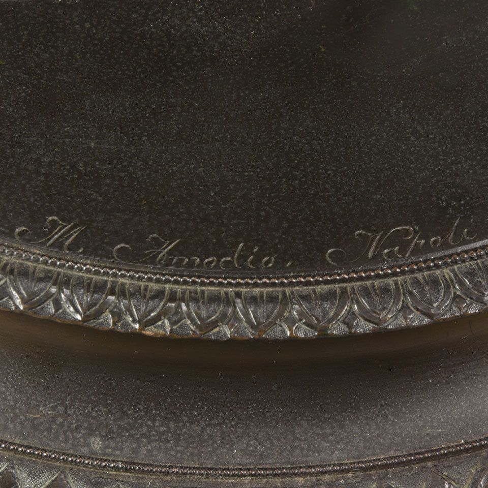 Callipygian Venus an Antique Bronze Figure depicting a partially draped woman, raising her light peplos (draped clothing) to uncover her hips and buttocks, and looking back and down over her shoulder