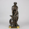 Thetis by Emile Hébert - a French late 19th Century bronze, of a striking female warrior figure known as Thetis the Greek Goddess of War. She is adjusting her shin guards in preparation for her next opponent, whilst sitting on an anvil. Raised on top of a partly gilded base