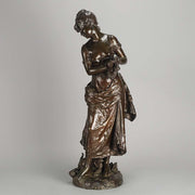An antique bronze figures Femme avec chat by H Moreau A charming bronze study of a young girl looking down at her feet where her cat is standing exhibiting excellent rich brown patina and very fine hand finished detail
