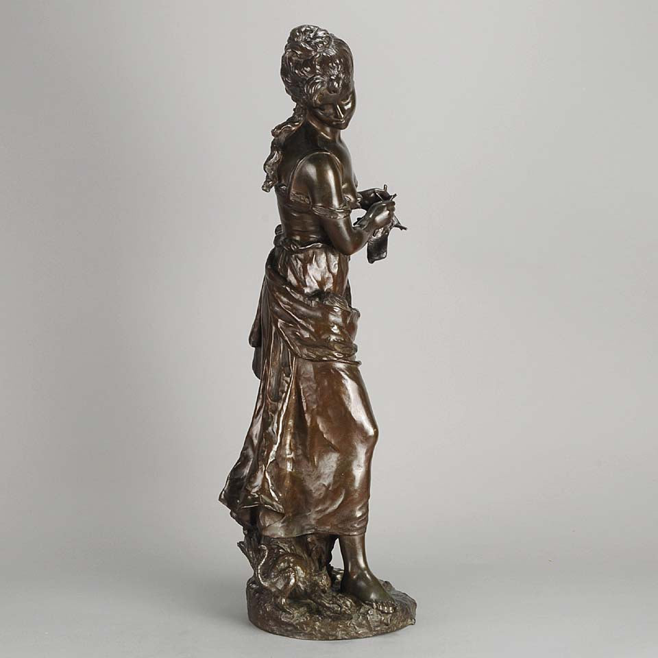 An antique bronze figures Femme avec chat by H Moreau A charming bronze study of a young girl looking down at her feet where her cat is standing exhibiting excellent rich brown patina and very fine hand finished detail