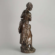 An antique bronze figures Femme avec chat by H Moreau A charming bronze study of a young girl looking down at her feet where her cat is standing exhibiting excellent rich brown patina and very fine hand finished detail