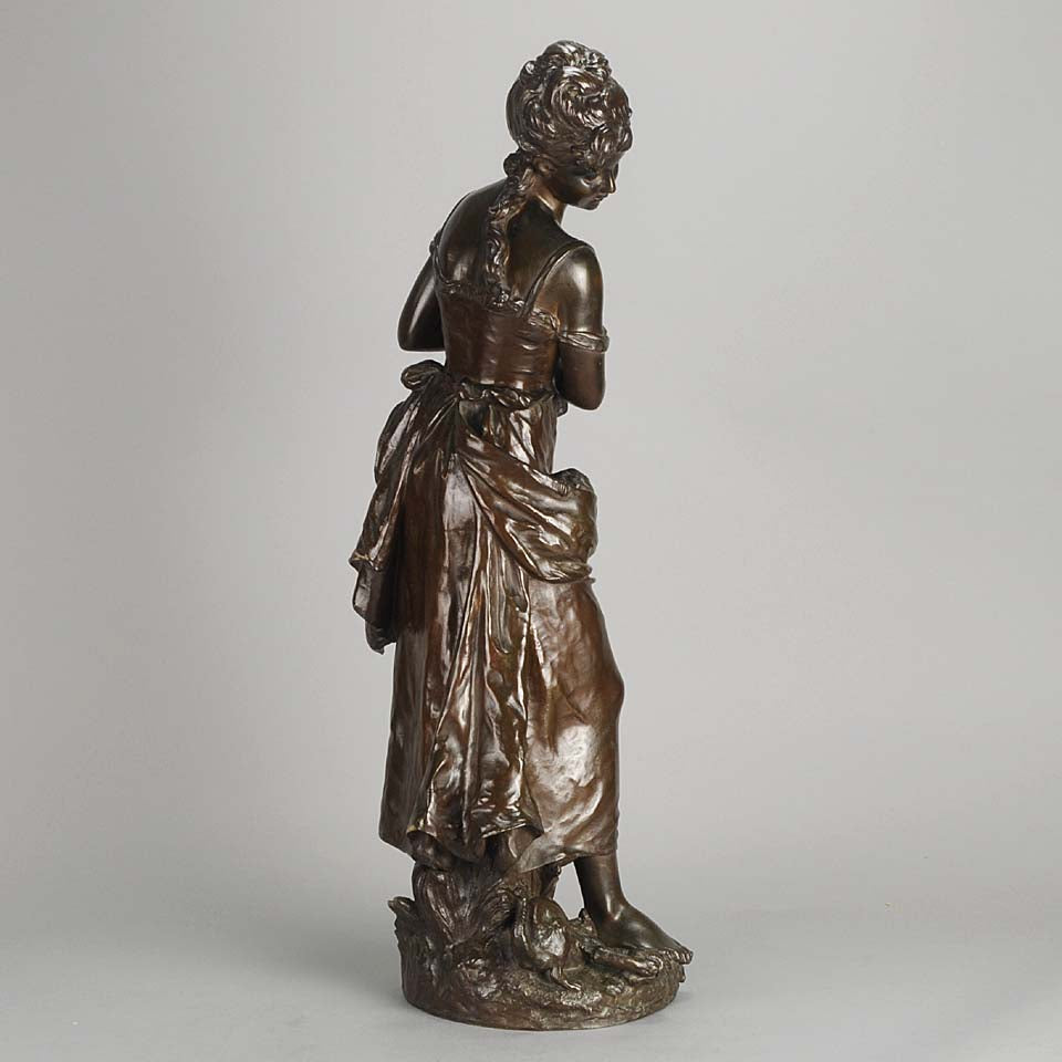 An antique bronze figures Femme avec chat by H Moreau A charming bronze study of a young girl looking down at her feet where her cat is standing exhibiting excellent rich brown patina and very fine hand finished detail