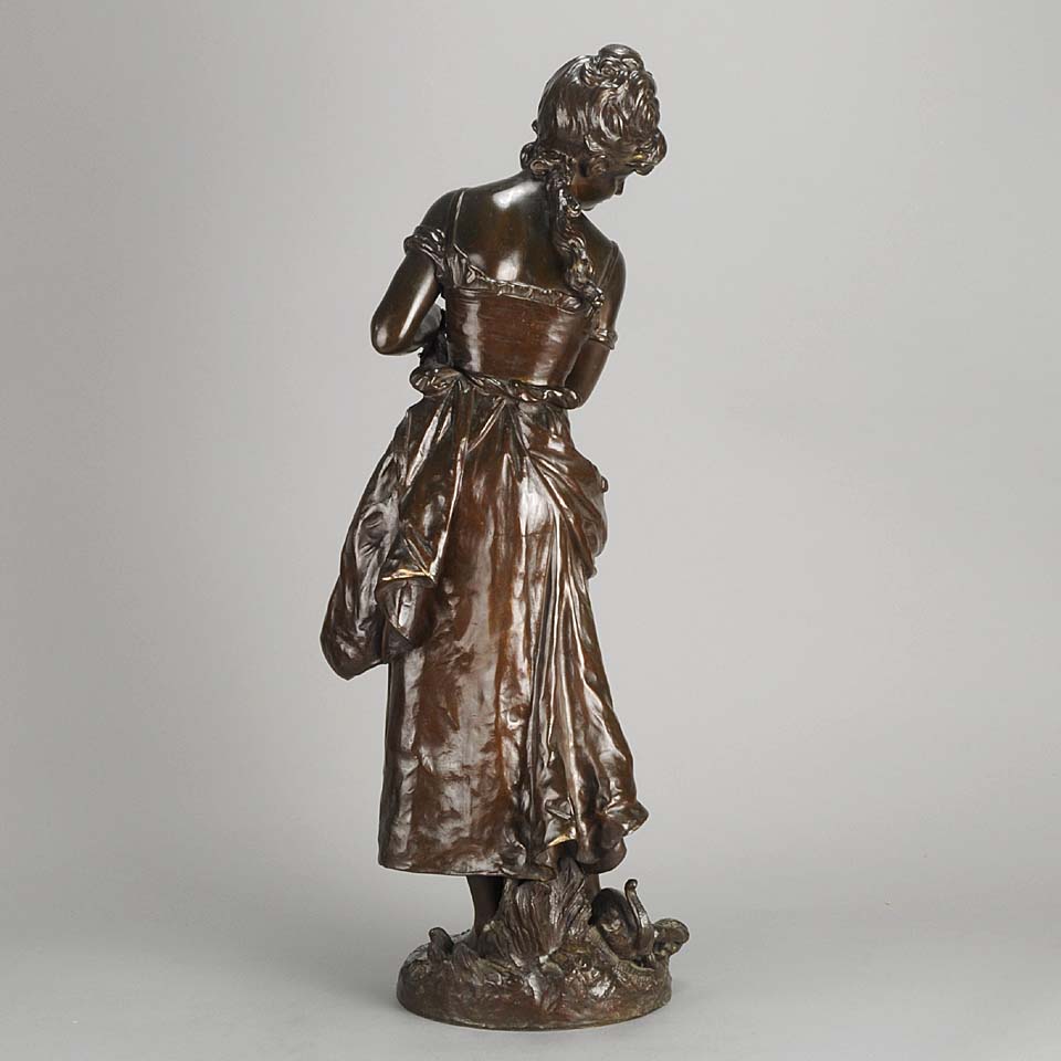 An antique bronze figures Femme avec chat by H Moreau A charming bronze study of a young girl looking down at her feet where her cat is standing exhibiting excellent rich brown patina and very fine hand finished detail