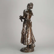 An antique bronze figures Femme avec chat by H Moreau A charming bronze study of a young girl looking down at her feet where her cat is standing exhibiting excellent rich brown patina and very fine hand finished detail