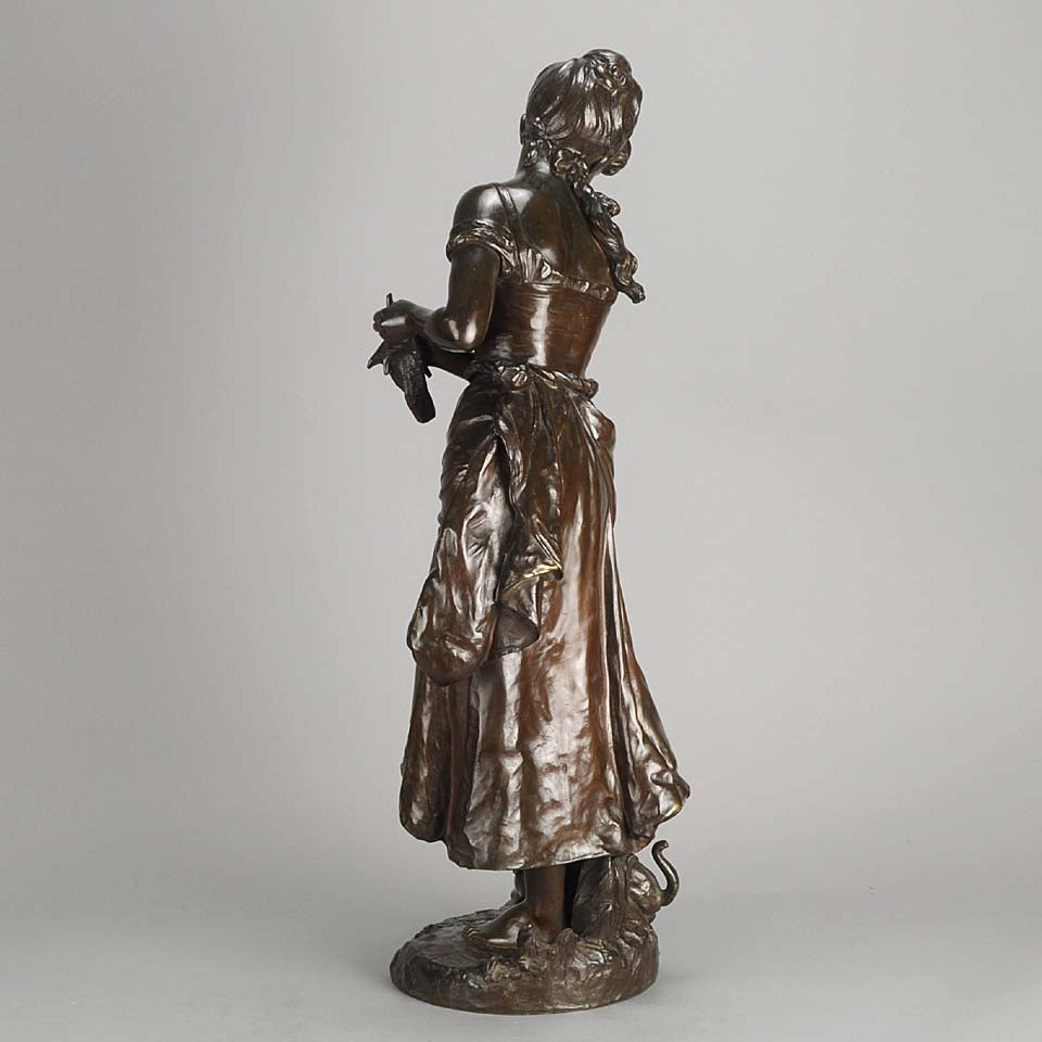 An antique bronze figures Femme avec chat by H Moreau A charming bronze study of a young girl looking down at her feet where her cat is standing exhibiting excellent rich brown patina and very fine hand finished detail