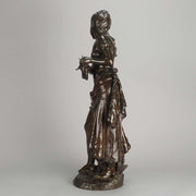 An antique bronze figures Femme avec chat by H Moreau A charming bronze study of a young girl looking down at her feet where her cat is standing exhibiting excellent rich brown patina and very fine hand finished detail