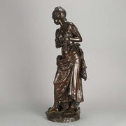 An antique bronze figures Femme avec chat by H Moreau A charming bronze study of a young girl looking down at her feet where her cat is standing exhibiting excellent rich brown patina and very fine hand finished detail
