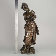 An antique bronze figures Femme avec chat by H Moreau A charming bronze study of a young girl looking down at her feet where her cat is standing exhibiting excellent rich brown patina and very fine hand finished detail
