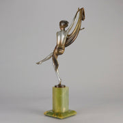 Charlotte by Josef Lorenzl a fabulous early 20th Century Art Deco cold painted bronze figure of a young woman holding an energetic pose lifting her shawl which is wrapped around her midriff.