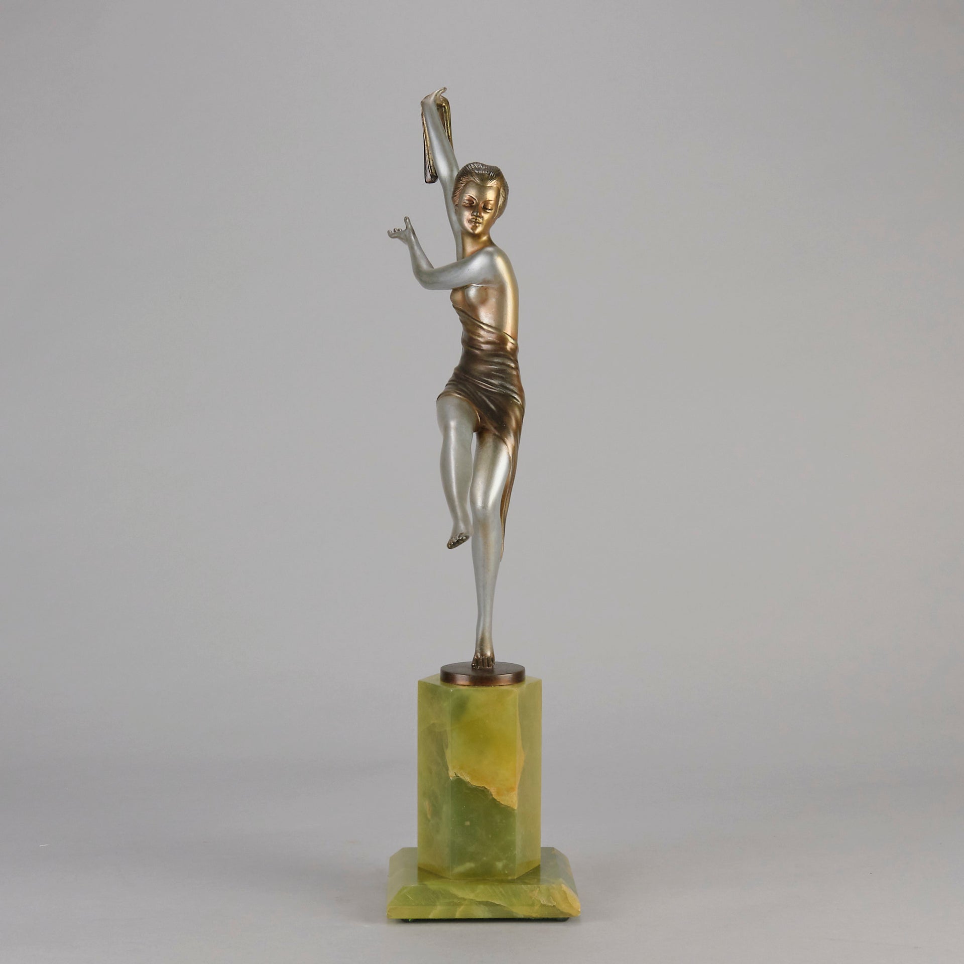 Charlotte by Josef Lorenzl a fabulous early 20th Century Art Deco cold painted bronze figure of a young woman holding an energetic pose lifting her shawl which is wrapped around her midriff.