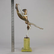 Charlotte by Josef Lorenzl a fabulous early 20th Century Art Deco cold painted bronze figure of a young woman holding an energetic pose lifting her shawl which is wrapped around her midriff.