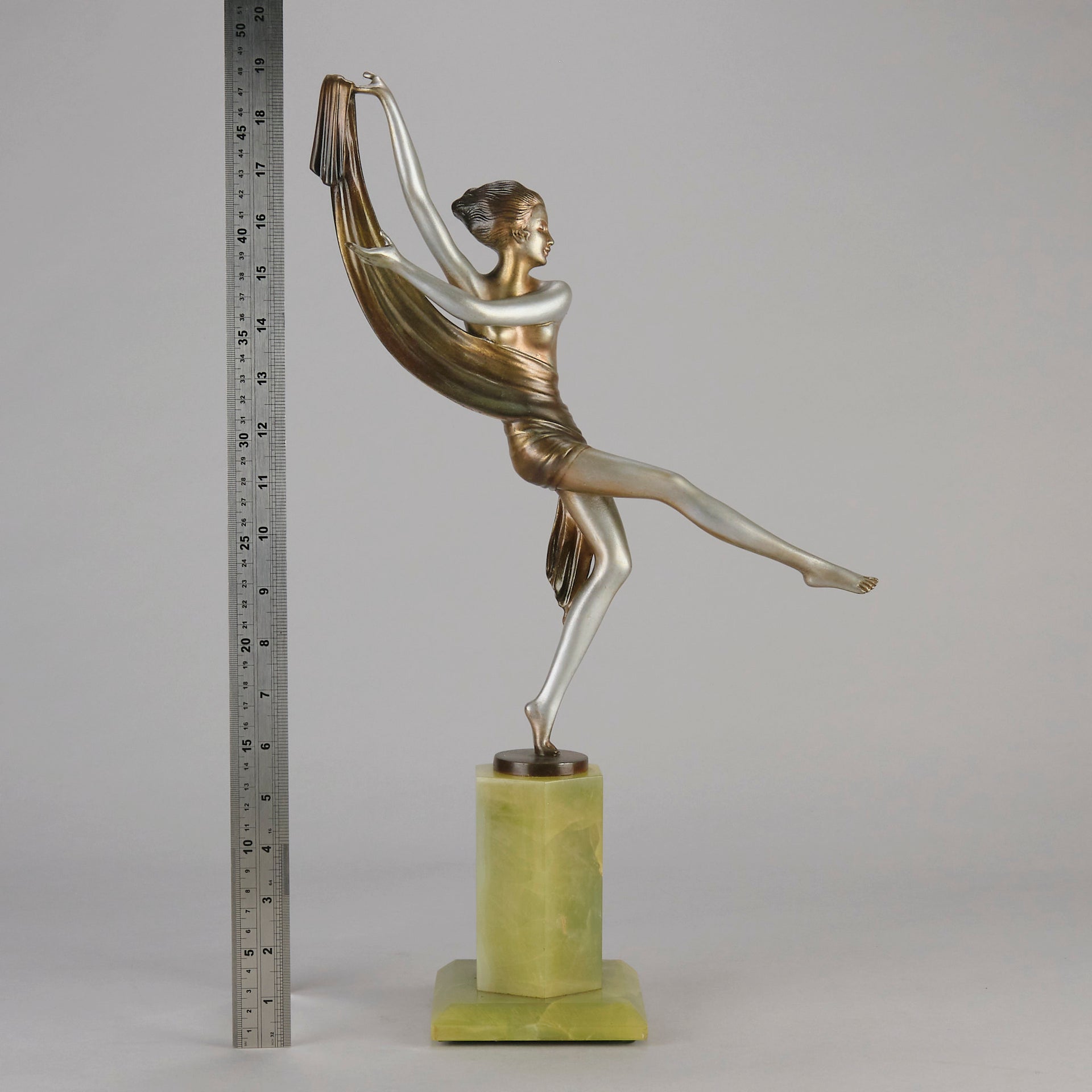 Charlotte by Josef Lorenzl a fabulous early 20th Century Art Deco cold painted bronze figure of a young woman holding an energetic pose lifting her shawl which is wrapped around her midriff.