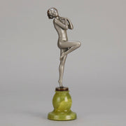 Art Deco Sculpture - Deco Dancer  by Josef Lorenzl  a cold painted bronze figure of a young woman holding a dancing pose with her hands lifted across her chest. The bronze figure with excellent colour and very fine hand chased surface detail, raised on a green onyx base  