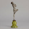 Art Deco Sculpture - Deco Dancer  by Josef Lorenzl  a cold painted bronze figure of a young woman holding a dancing pose with her hands lifted across her chest. The bronze figure with excellent colour and very fine hand chased surface detail, raised on a green onyx base  
