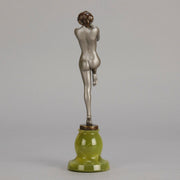 Art Deco Sculpture - Deco Dancer  by Josef Lorenzl  a cold painted bronze figure of a young woman holding a dancing pose with her hands lifted across her chest. The bronze figure with excellent colour and very fine hand chased surface detail, raised on a green onyx base  