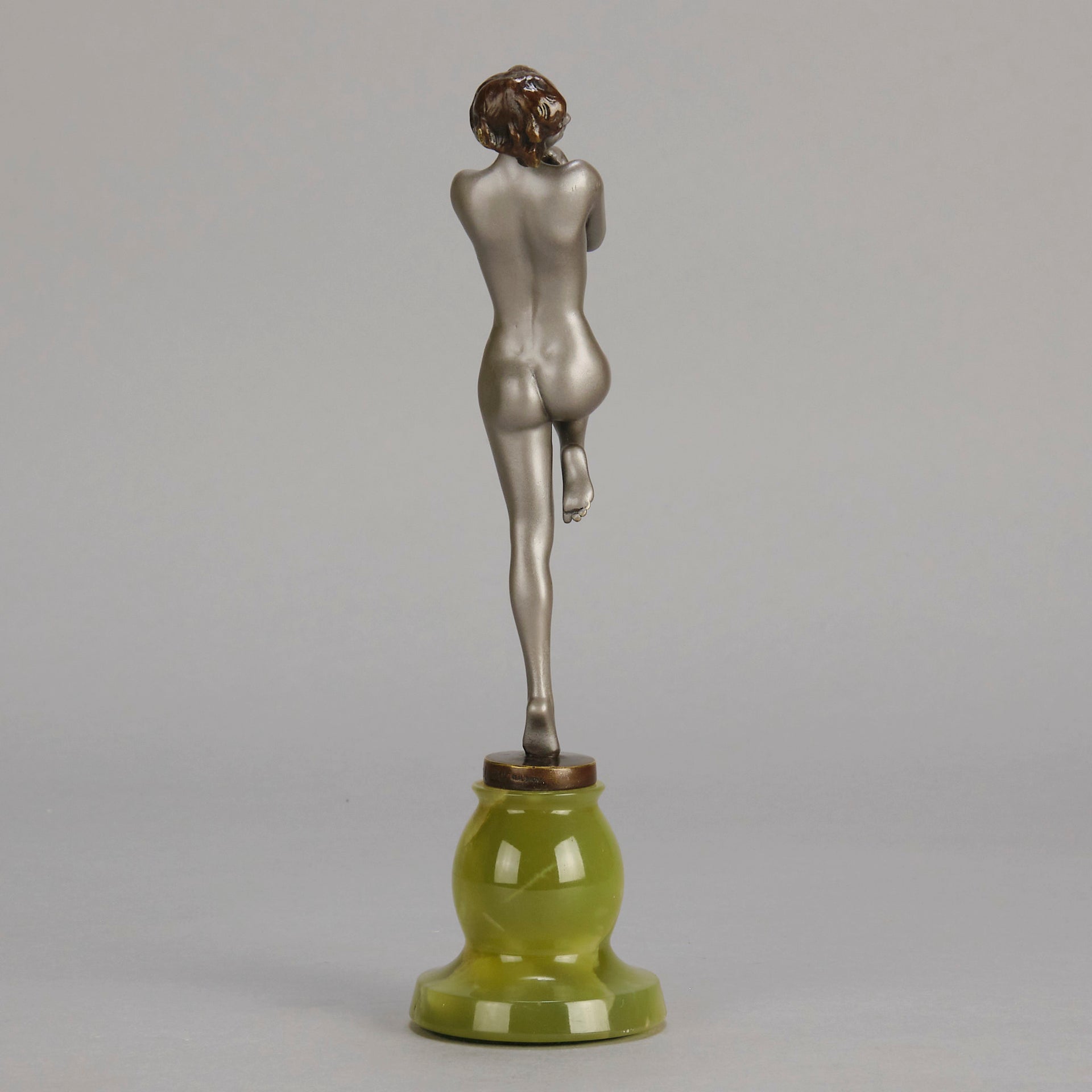 Art Deco Sculpture - Deco Dancer  by Josef Lorenzl  a cold painted bronze figure of a young woman holding a dancing pose with her hands lifted across her chest. The bronze figure with excellent colour and very fine hand chased surface detail, raised on a green onyx base  