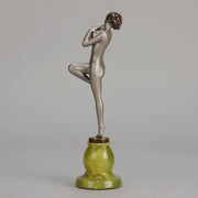 Art Deco Sculpture - Deco Dancer  by Josef Lorenzl  a cold painted bronze figure of a young woman holding a dancing pose with her hands lifted across her chest. The bronze figure with excellent colour and very fine hand chased surface detail, raised on a green onyx base  