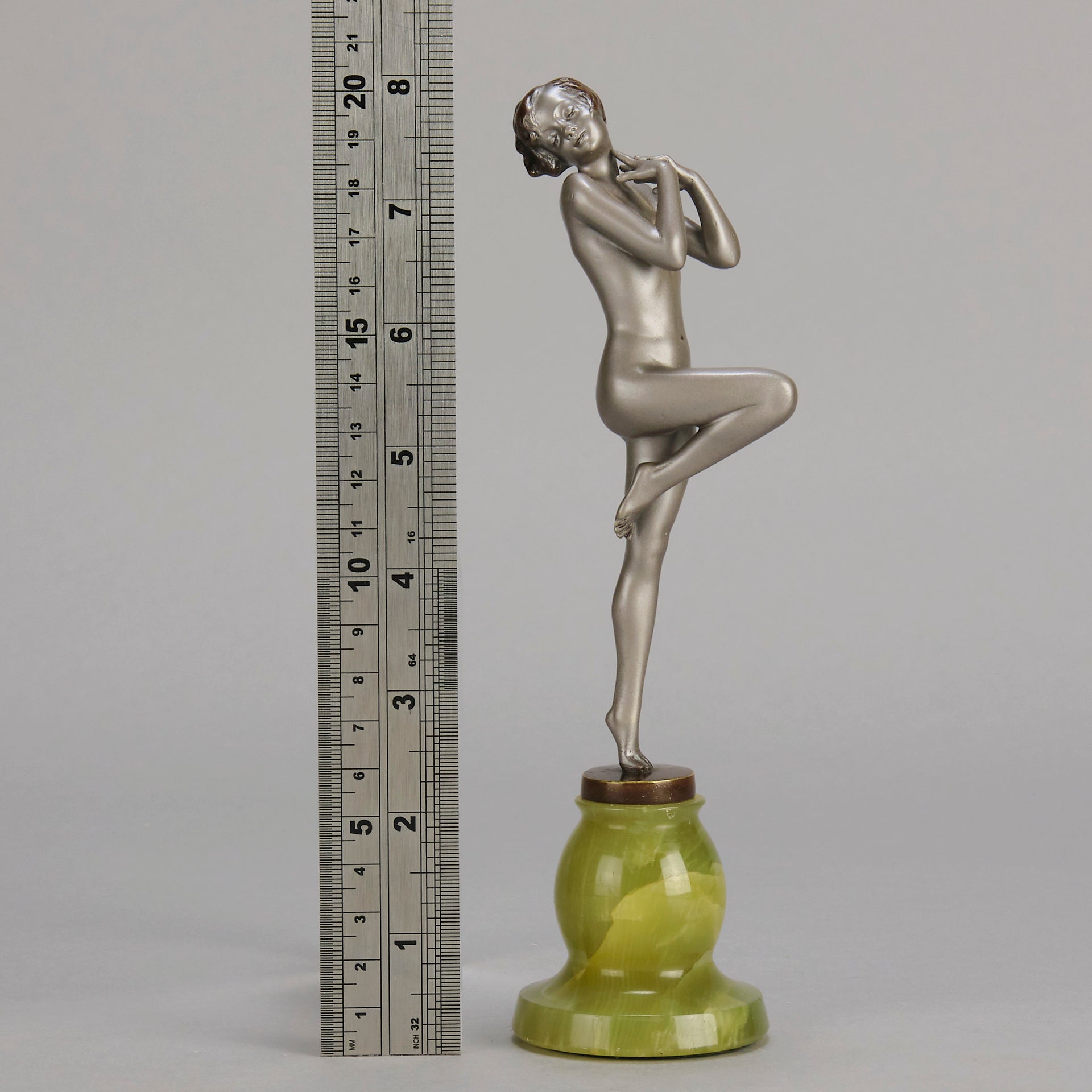 Art Deco Sculpture - Deco Dancer  by Josef Lorenzl  a cold painted bronze figure of a young woman holding a dancing pose with her hands lifted across her chest. The bronze figure with excellent colour and very fine hand chased surface detail, raised on a green onyx base  
