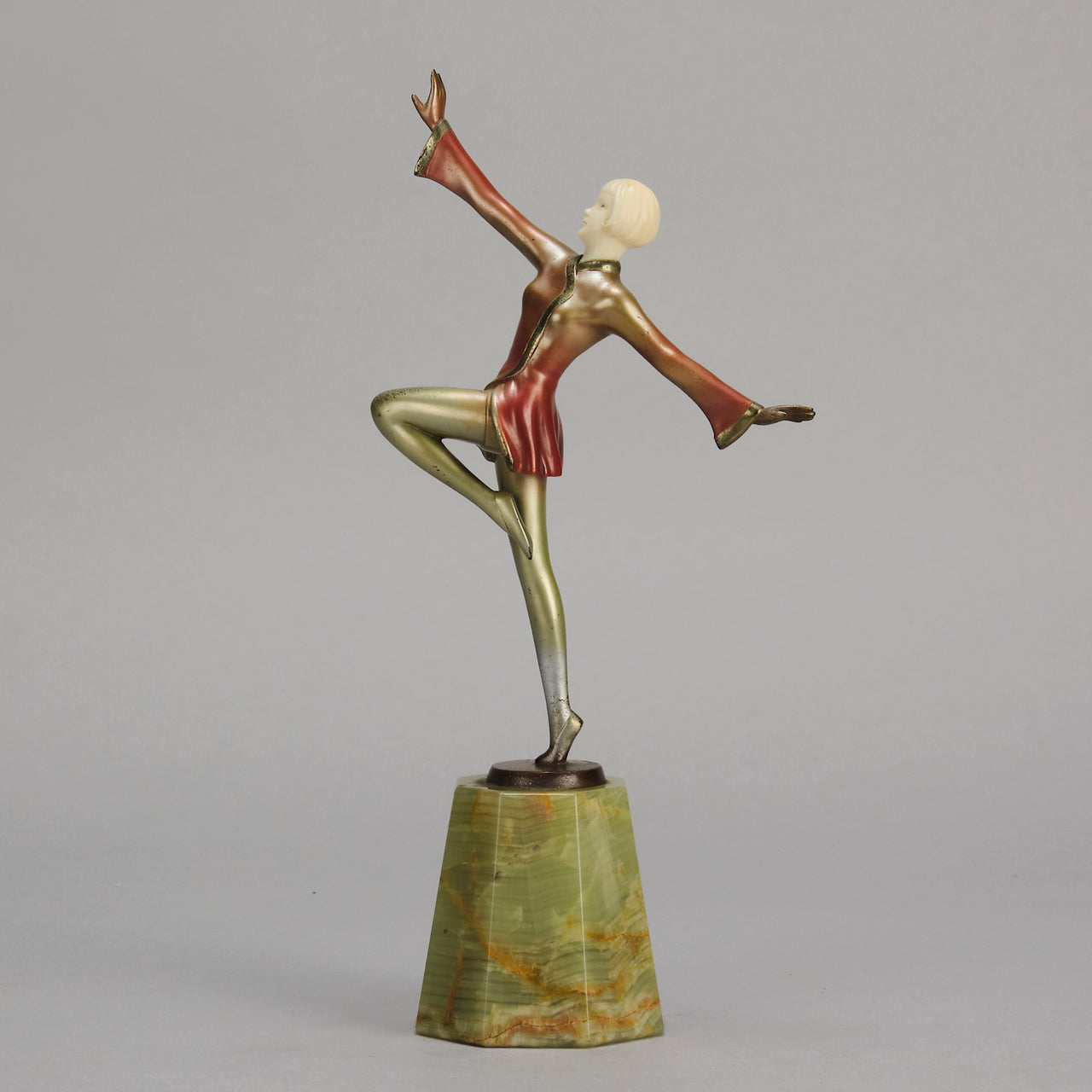 Helga by Josef Lorenzl An Art Deco Bronze and ivory igure of a beautiful dancer holding an elegant pose exhibiting excellent colour and very fine hand chased surface detail, raised on a green onyx base 