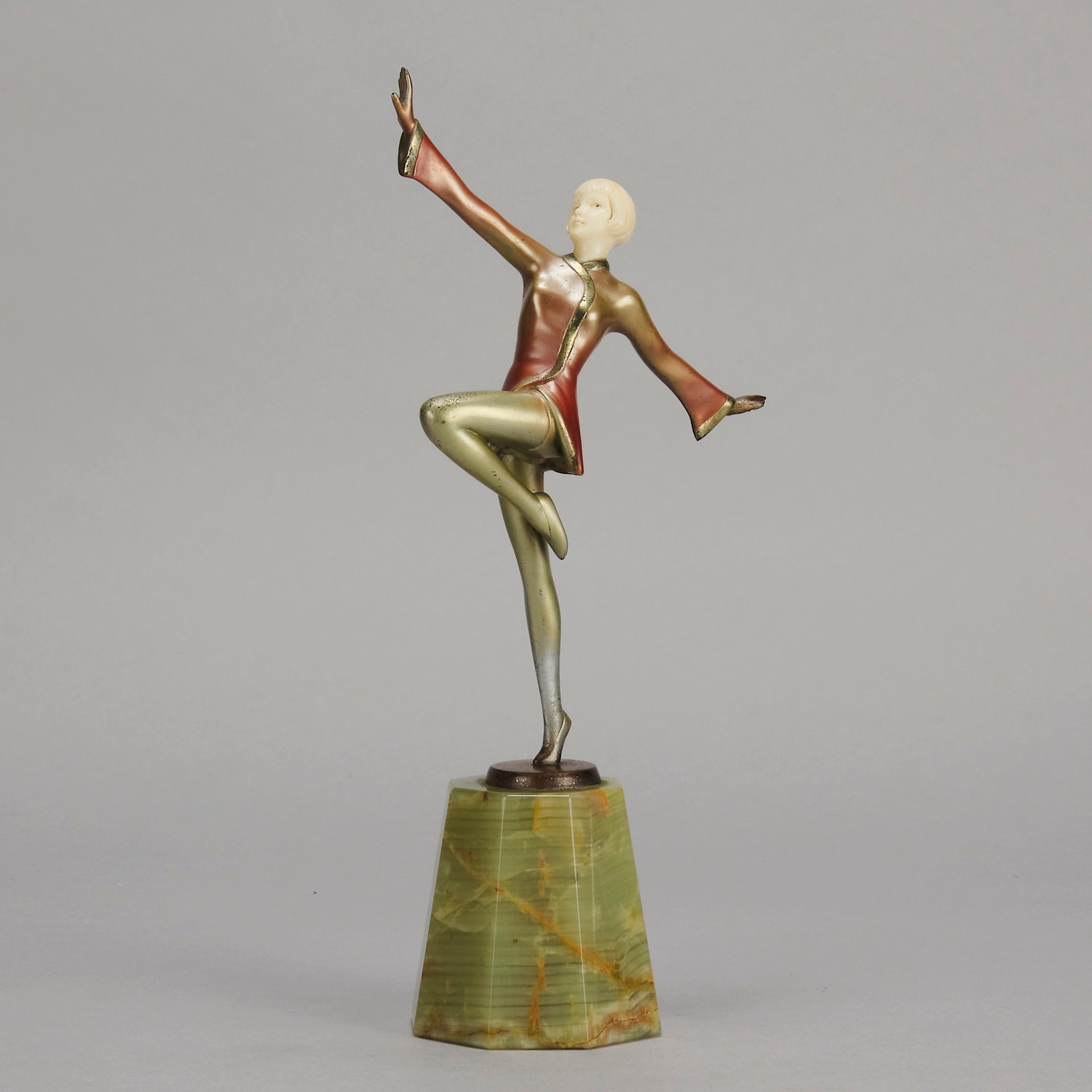 Helga by Josef Lorenzl An Art Deco Bronze and ivory igure of a beautiful dancer holding an elegant pose exhibiting excellent colour and very fine hand chased surface detail, raised on a green onyx base 