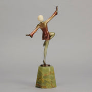 Helga by Josef Lorenzl An Art Deco Bronze and ivory igure of a beautiful dancer holding an elegant pose exhibiting excellent colour and very fine hand chased surface detail, raised on a green onyx base 