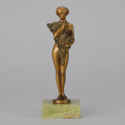 The Bouquet by Joseph Lorenzl an elegant early 20th Century Art Deco cold painted bronze figure of a young beauty holding a large bouquet of flowers covering her modesty raised on a green onyx base 
