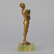 The Bouquet by Joseph Lorenzl an elegant early 20th Century Art Deco cold painted bronze figure of a young beauty holding a large bouquet of flowers covering her modesty raised on a green onyx base 