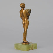 The Bouquet by Joseph Lorenzl an elegant early 20th Century Art Deco cold painted bronze figure of a young beauty holding a large bouquet of flowers covering her modesty raised on a green onyx base 