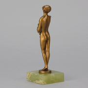 The Bouquet by Joseph Lorenzl an elegant early 20th Century Art Deco cold painted bronze figure of a young beauty holding a large bouquet of flowers covering her modesty raised on a green onyx base 