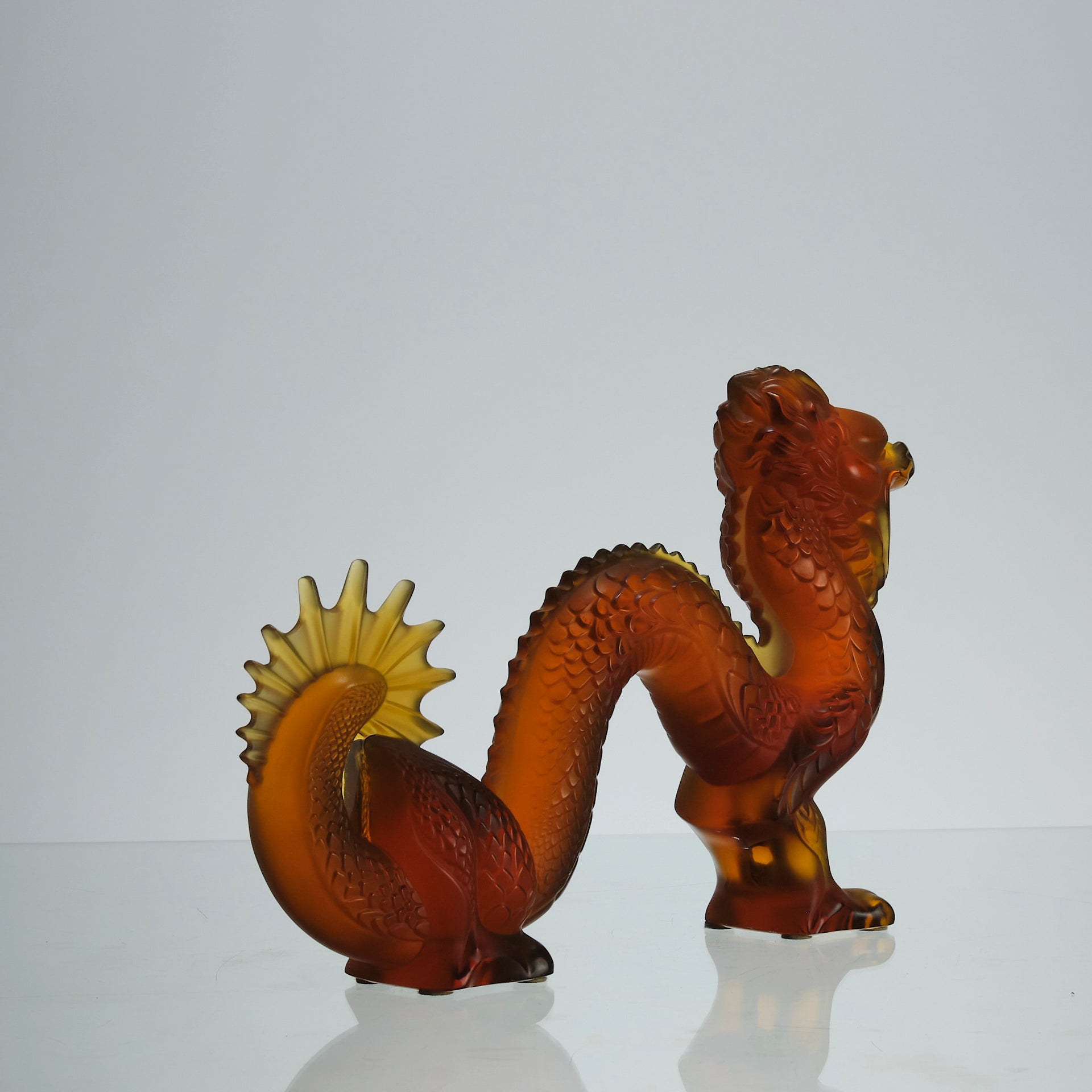 Oriental Dragon by Marie-Claude Lalique A striking mid 20th Century glass study of an Oriental dragon of undulating form with very fine hand chased surface detail and dramatic orange colour