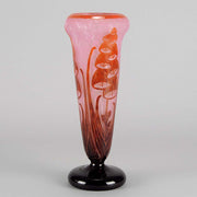 Digitale Vase by Le Verre Francais a striking cameo glass vase decorated with a red and maroon Art Deco design of digitalis flowers against a light pink field