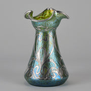 Silvered Papillon Vase by Loetz Witwe Art Nouveau tourquoise papillon glass vase, decorated with an applied silver floral organic pattern that wraps around the circumference of the body