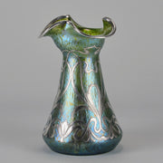 Silvered Papillon Vase by Loetz Witwe Art Nouveau tourquoise papillon glass vase, decorated with an applied silver floral organic pattern that wraps around the circumference of the body
