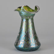 Silvered Papillon Vase by Loetz Witwe Art Nouveau tourquoise papillon glass vase, decorated with an applied silver floral organic pattern that wraps around the circumference of the body